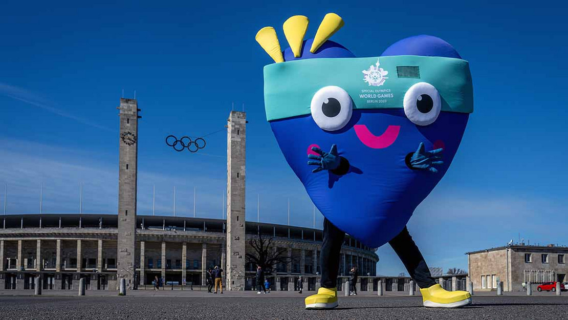 Maskottchen (große blaues Herz) steht vor dem Olympiastadion in Berlin. 